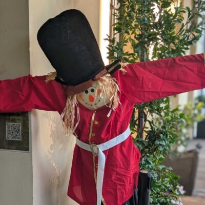 Bear & Crown scarecrow in a tall black hat and red coat