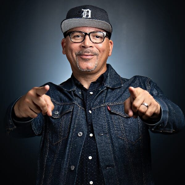data-14 Comedian Key Lewis in a cap and denim jacket pointing at the camera